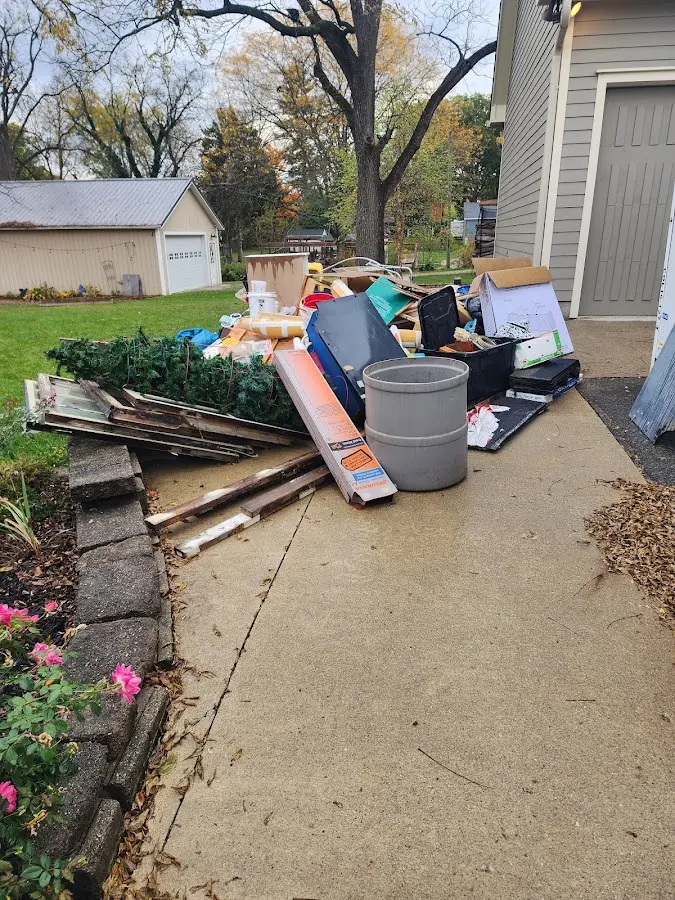 Dumpster being loaded with debris for Estate Cleanout Dumpster Rental in Southport
